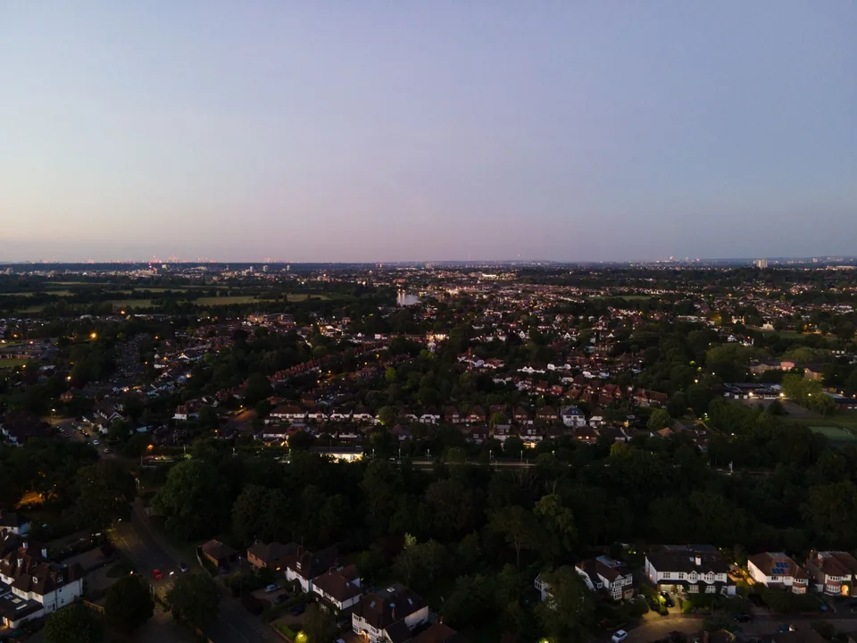 A residential neighbourhood from above at dusk under a lavender horizon