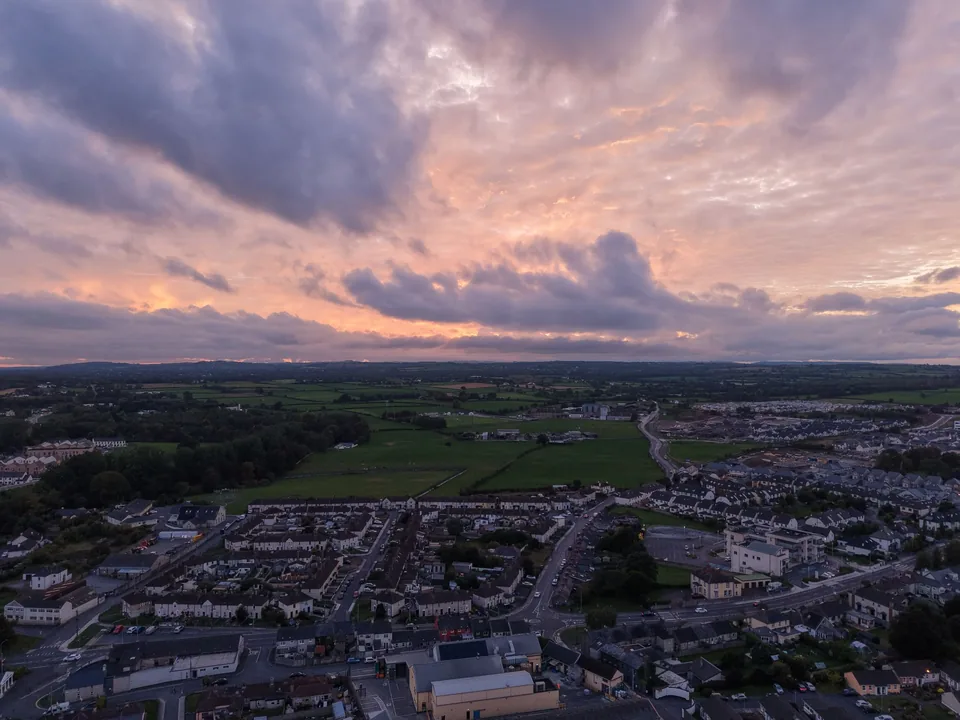 A town at sunset beneath lavender clouds